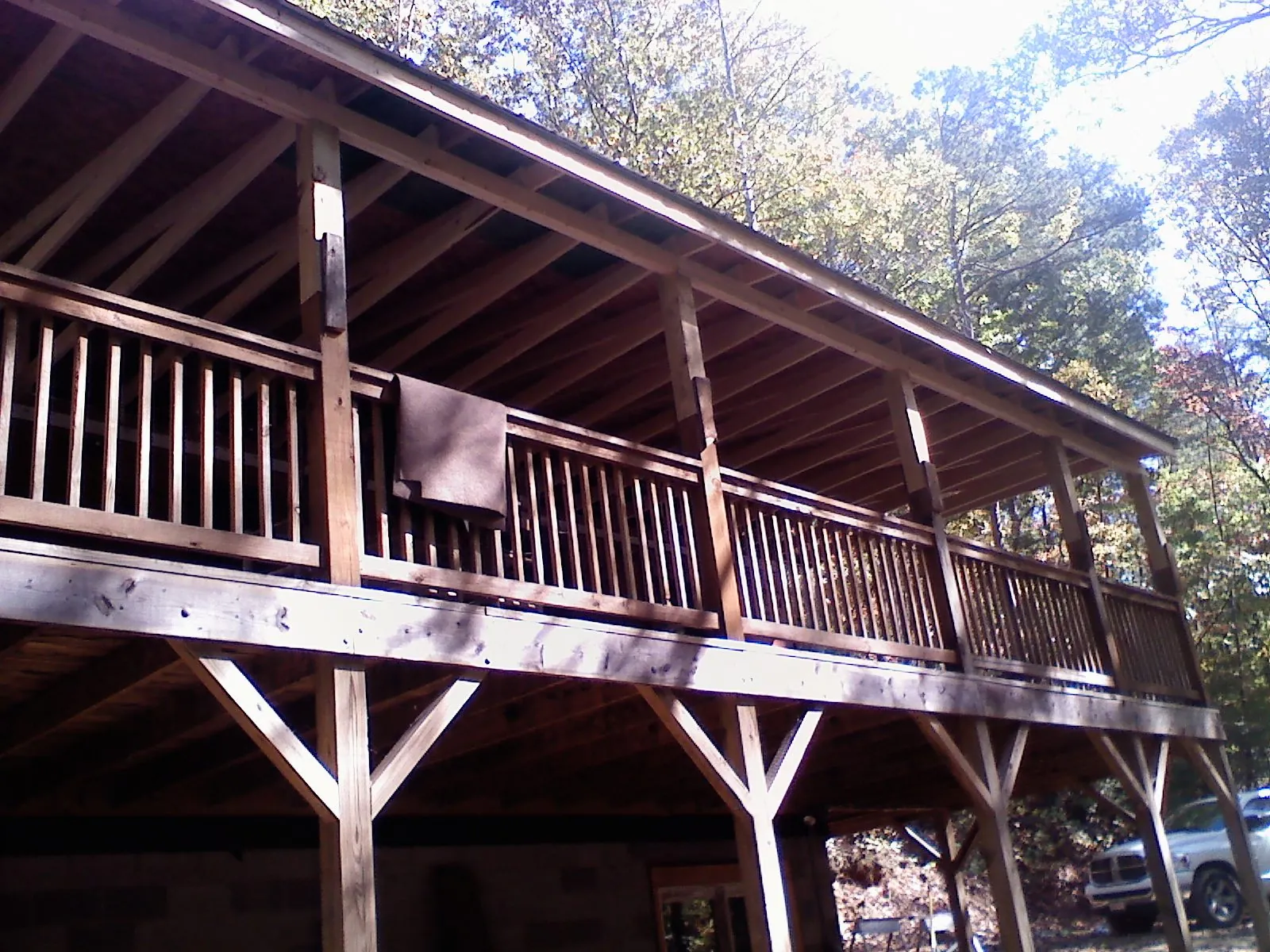 Timber framing under a new elevated porch and deck in Percival